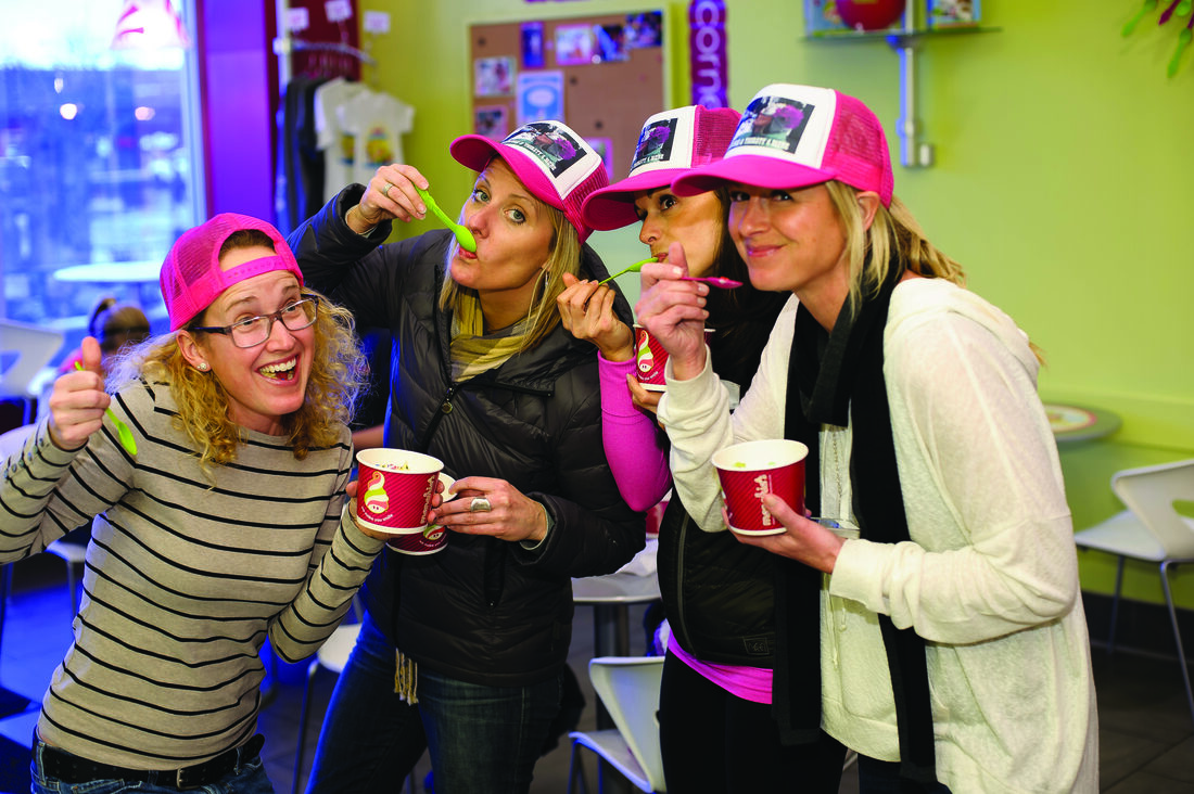 A group of friends having fun with Menchie's frozen yogurt