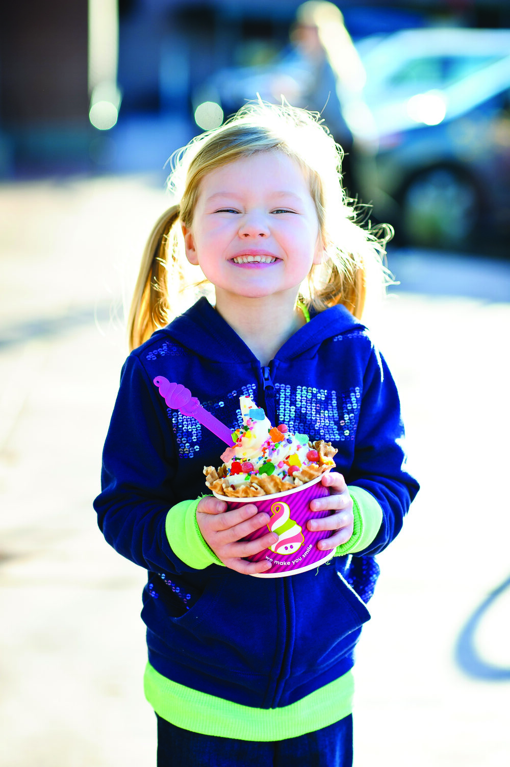 A young guest holding a Menchie's frozen yogurt cup